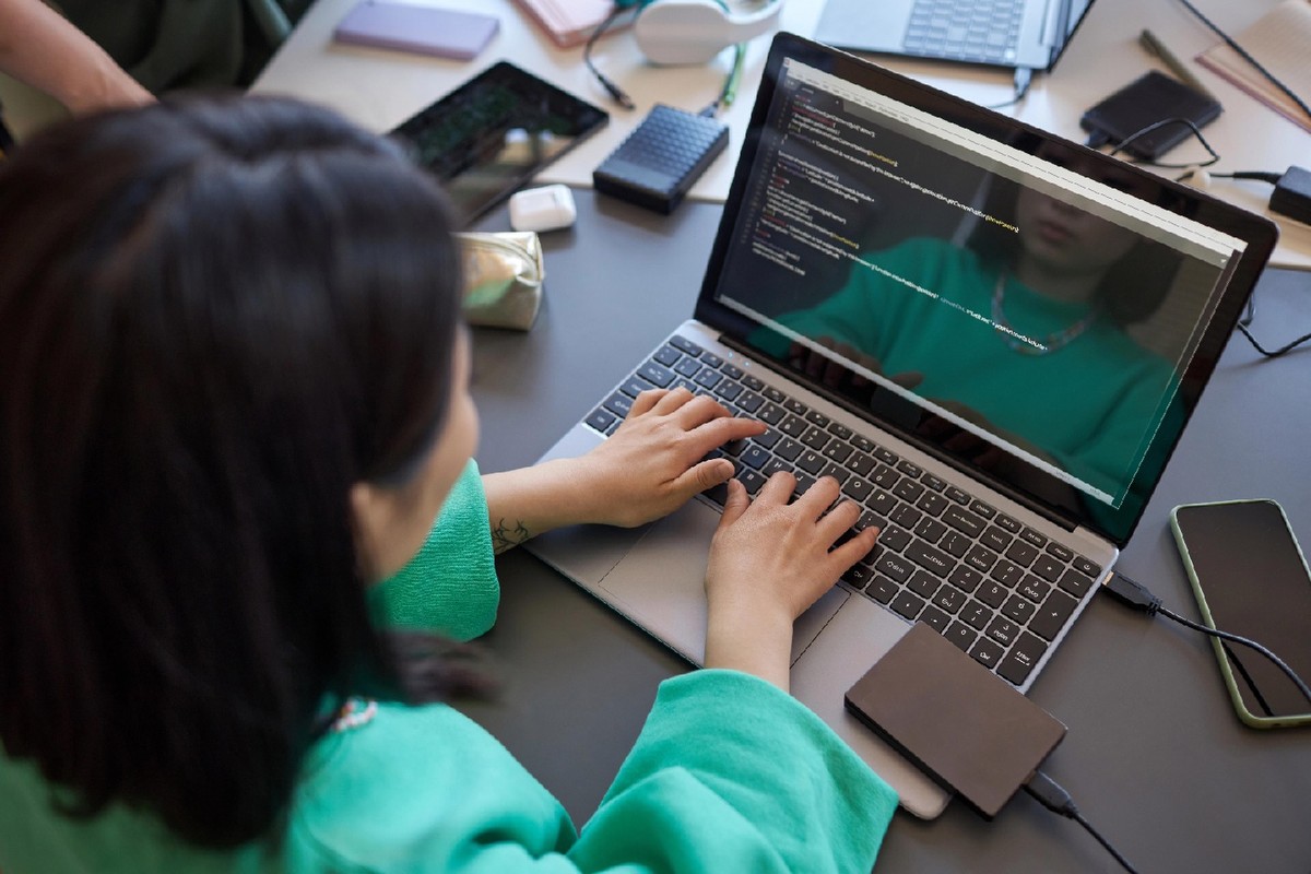 A young woman works at a computer